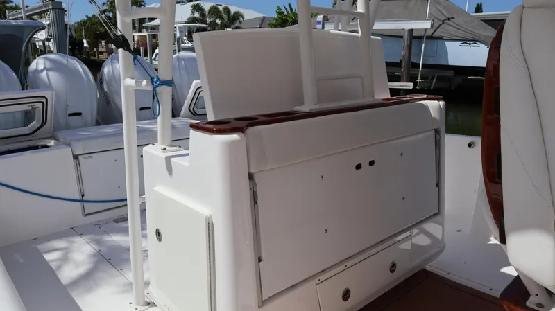 Slide: The Image of 2019 Everglades 435 Center Console boat interior with seating and storage compartments. - 37