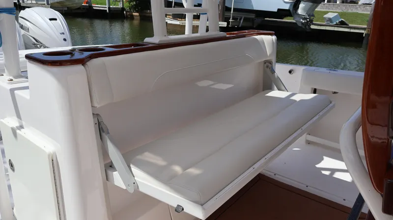 Slide: The Image of 2019 Everglades 435 Center Console boat with foldable white bench seat. - 38