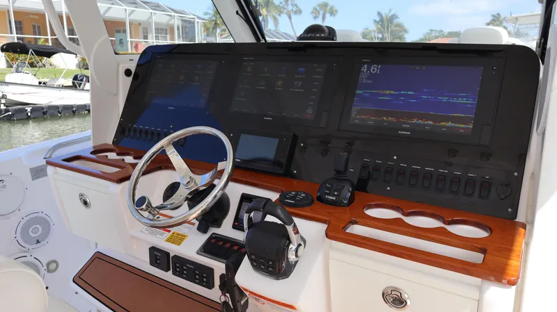 Slide: The Image of 2019 Everglades 435 Center Console boat dashboard with advanced navigation displays. - 46
