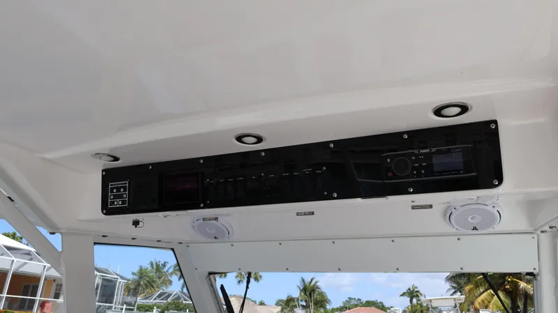 Slide: The Image of Interior view of 2019 Everglades 435 Center Console boat with control panel and speakers. - 47