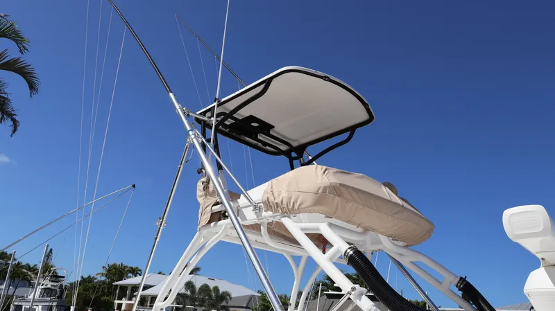 Slide: The Image of 2019 Everglades 435 Center Console boat with fishing rods against clear blue sky. - 5