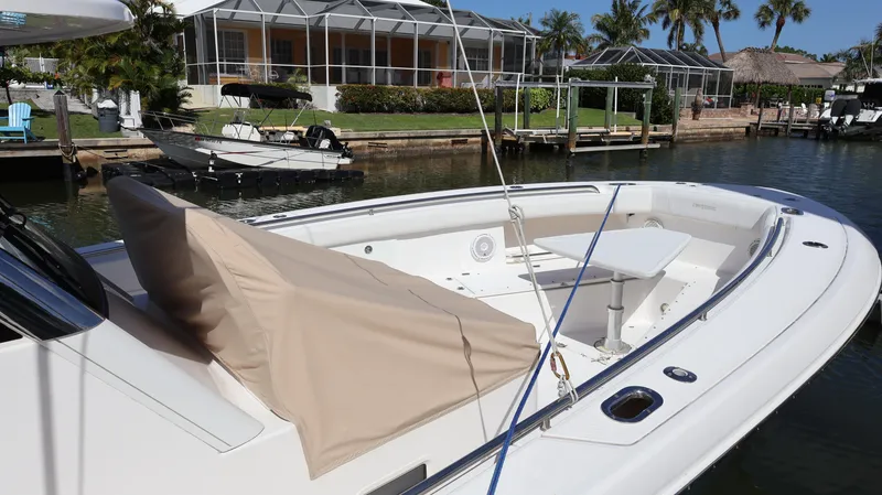Slide: The Image of 2019 Everglades 435 Center Console boat docked near waterfront homes. - 6