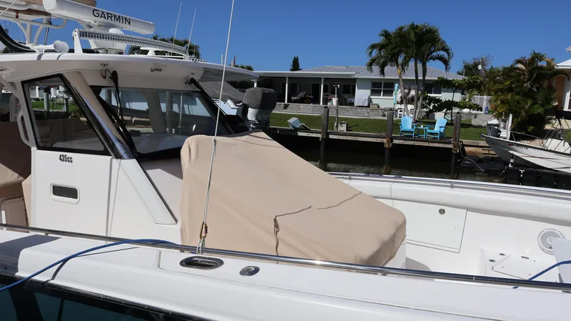 Slide: The Image of 2019 Everglades 435 Center Console boat docked near waterfront homes. - 7