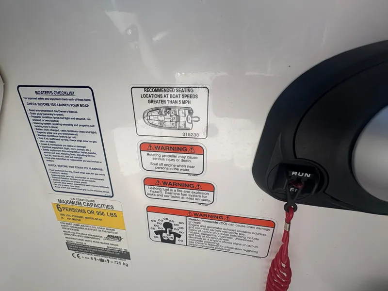 Slide: The Image of 2024 Tahoe T16 boat dashboard with safety warnings and ignition switch. - 10