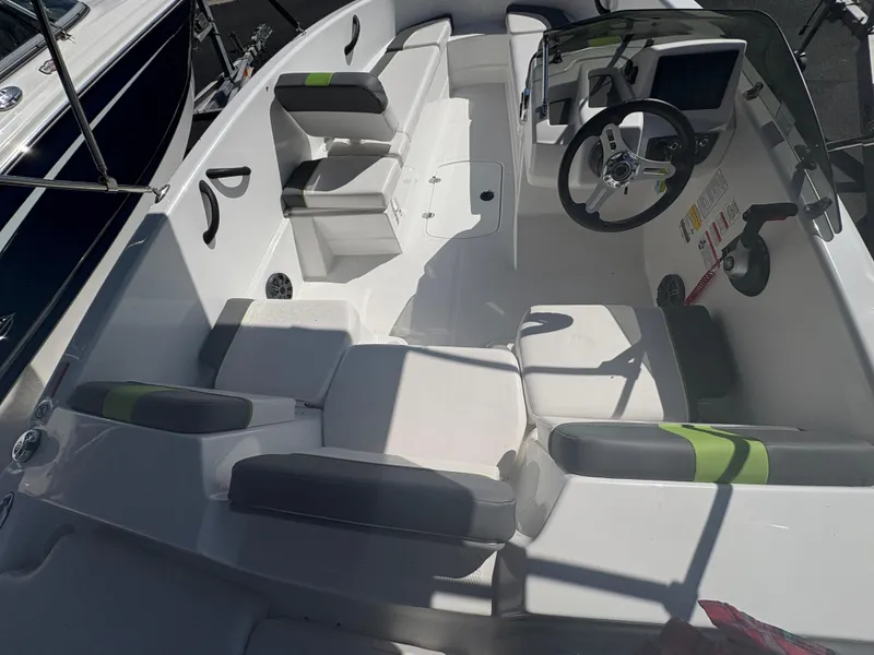 Slide: The Image of 2024 Tahoe T16 boat interior with seating and steering wheel, featuring modern design elements. - 12