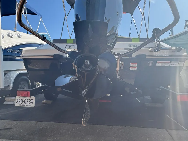 Slide: The Image of 2024 Tahoe T16 boat with outboard motor and propeller, docked under clear blue sky. - 15