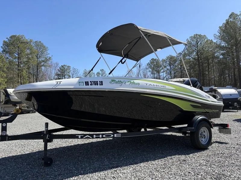 Slide: The Image of 2024 Tahoe T16 boat on trailer with canopy, parked outdoors. - 3