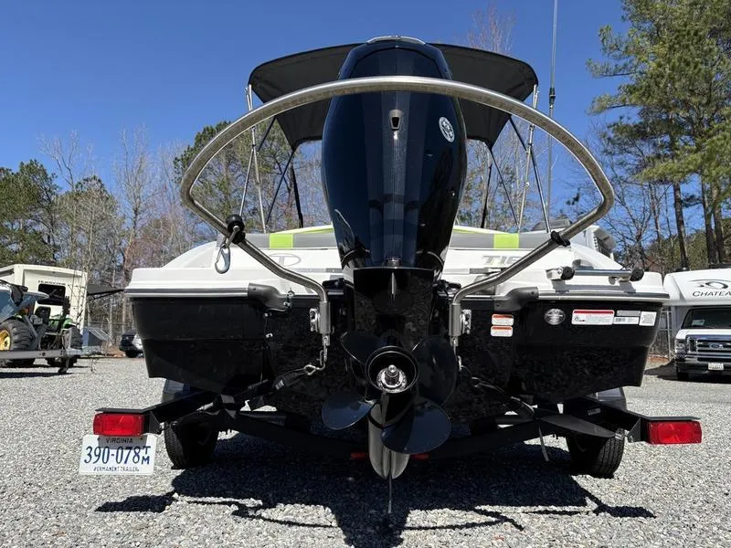 Slide: The Image of 2024 Tahoe T16 boat rear view with outboard motor in a parking area. - 4