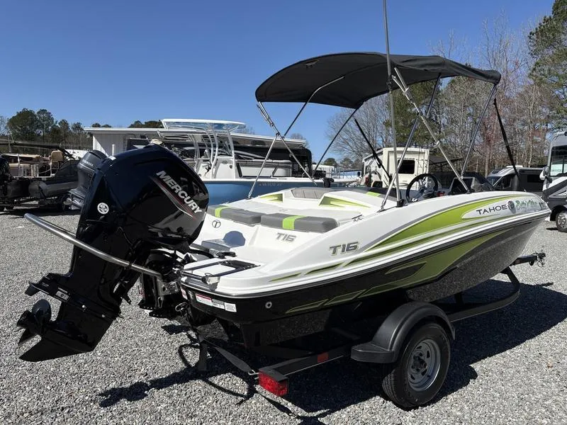 Slide: The Image of 2024 Tahoe T16 boat with Mercury engine on trailer, parked outdoors. - 5