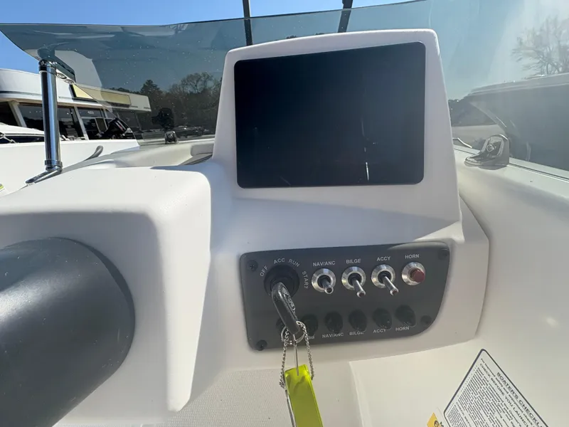 Slide: The Image of 2024 Tahoe T16 boat dashboard with control panel and screen. - 9