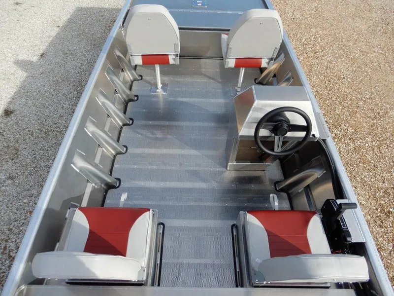 Slide: The Image of 2025 Blazer 1752 SC boat interior with red and gray seating, steering console, and aluminum flooring. - 14