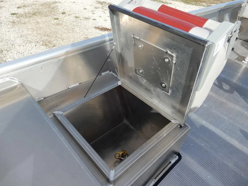 Slide: The Image of Open storage compartment on 2025 Blazer 1752 SC boat, featuring metallic finish and red seat. - 17