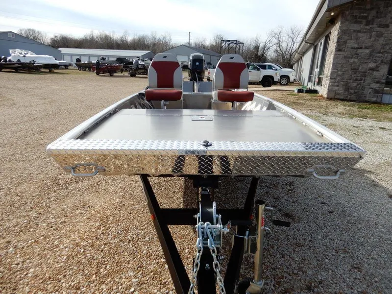 Slide: The Image of 2025 Blazer 1752 SC boat with dual red seats, parked outdoors on gravel. - 3