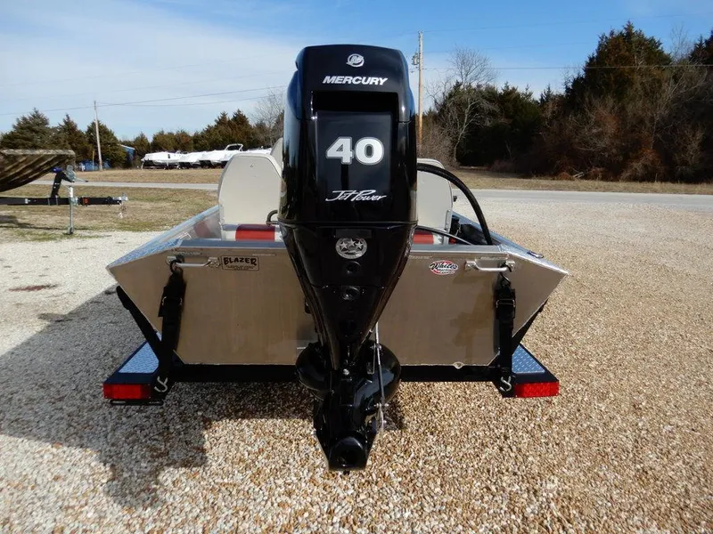 Slide: The Image of 2025 Blazer 1752 SC boat with Mercury 40 HP outboard motor, parked on gravel. - 6