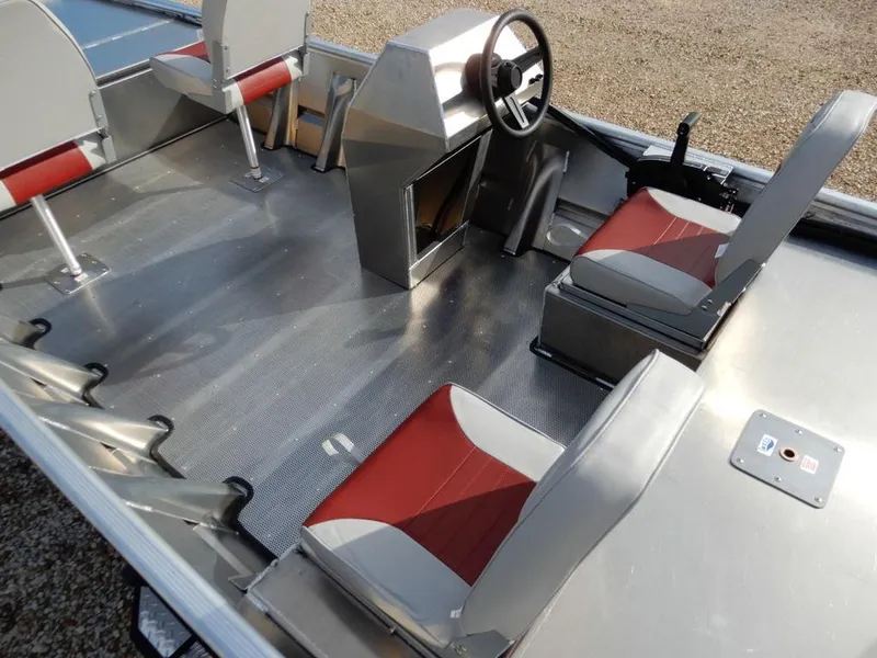 Slide: The Image of 2025 Blazer 1752 SC boat interior with red and gray seating, steering console, and aluminum flooring. - 8
