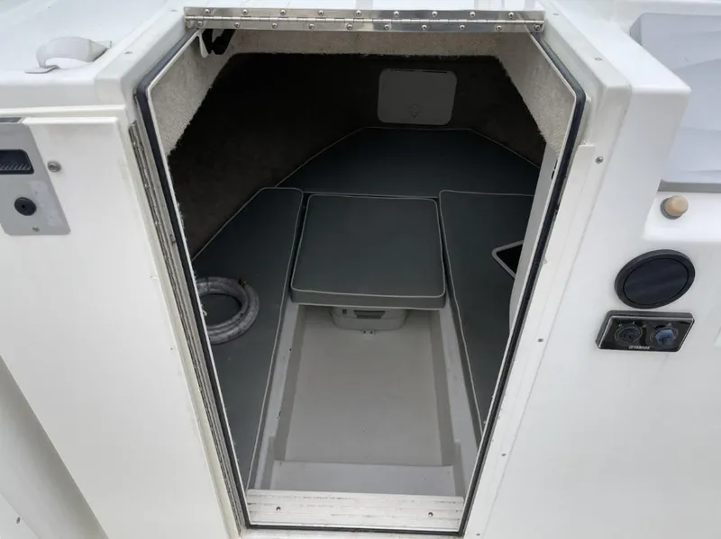 Slide: The Image of 2014 Parker 2310 Walkaround cabin interior with seating and storage. - 12