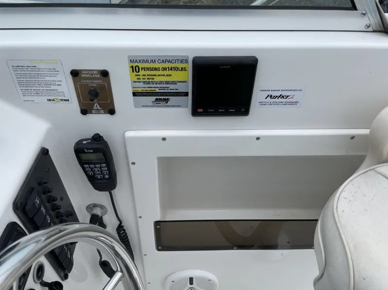 Slide: The Image of Control panel of a 2014 Parker 2310 Walkaround boat with capacity and equipment details. - 15