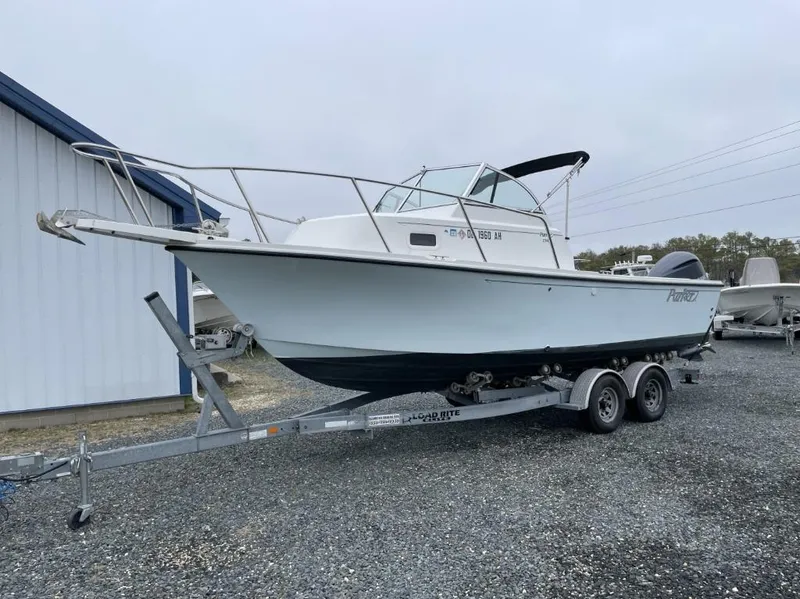 Slide: The Image of 2014 Parker 2310 Walkaround boat on trailer, parked outdoors near a building. - 5