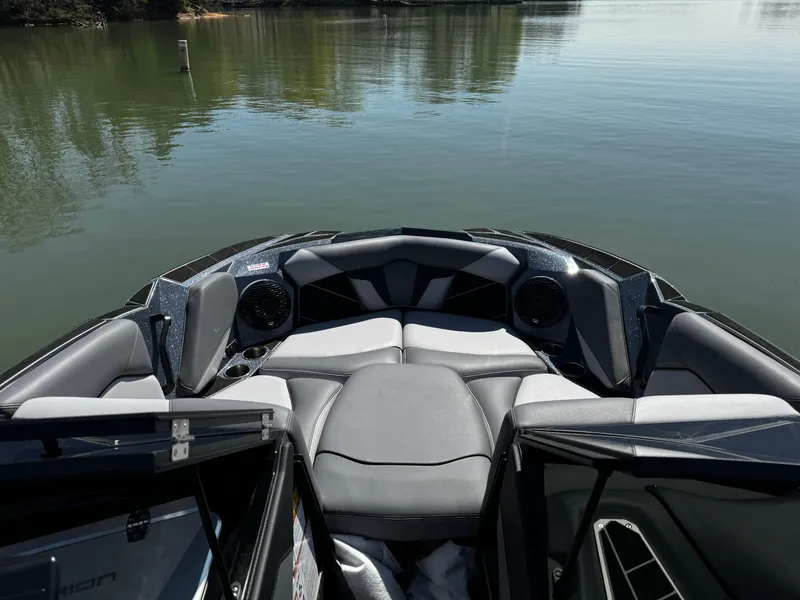 Slide: The Image of 2025 Centurion Fe23 boat interior with sleek seating on calm water. - 14