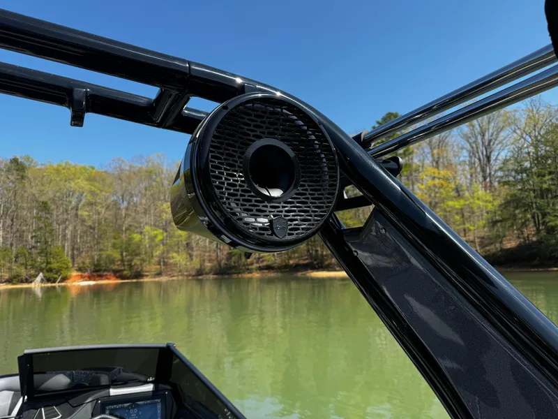Slide: The Image of 2025 Centurion Fe23 boat with mounted speaker on a lake. - 18
