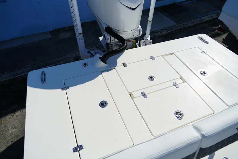 Slide: The Image of 2025 Hewes Redfisher 21 boat deck with storage compartments and motor. - 12