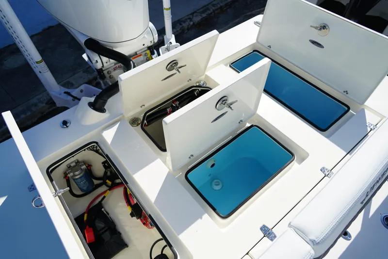 Slide: The Image of 2025 Hewes Redfisher 21 boat compartments with open hatches and visible storage areas. - 14