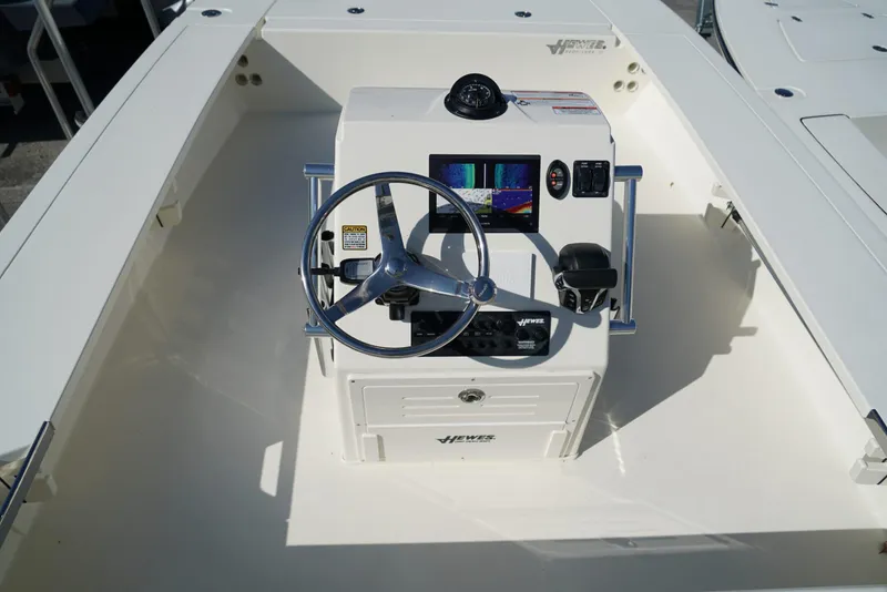 Slide: The Image of 2025 Hewes Redfisher 21 boat console with steering wheel and navigation display. - 15