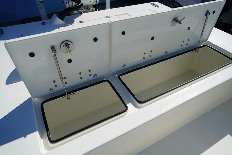 Slide: The Image of 2025 Hewes Redfisher 21 boat storage compartments, open and empty, showcasing interior design. - 16