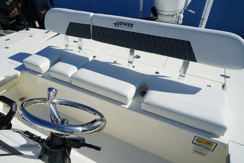 Slide: The Image of 2025 Hewes Redfisher 21 boat interior with steering wheel and cushioned seating. - 20