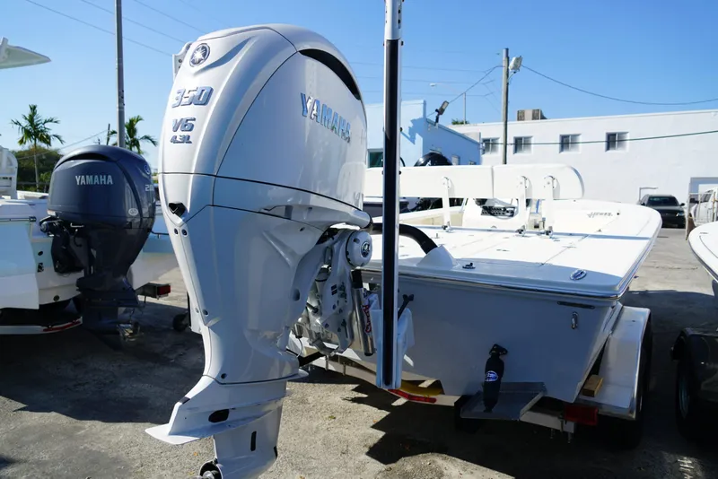 Slide: The Image of 2025 Hewes Redfisher 21 boat with Yamaha 350 V6 engine, parked outdoors. - 4