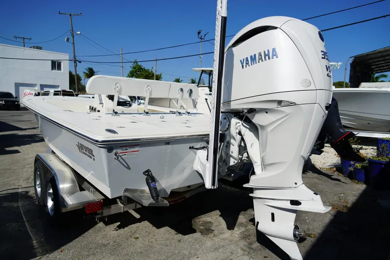 Slide: The Image of 2025 Hewes Redfisher 21 boat with Yamaha engine on trailer, parked outdoors. - 5