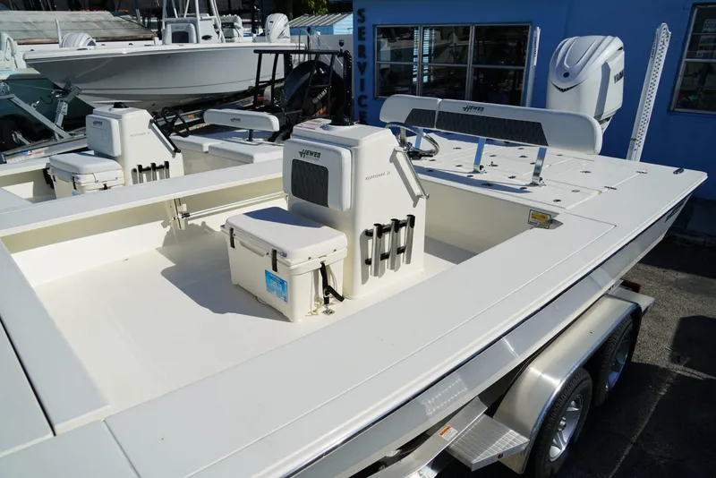 Slide: The Image of 2025 Hewes Redfisher 21 boat on trailer, featuring spacious deck and modern design. - 7