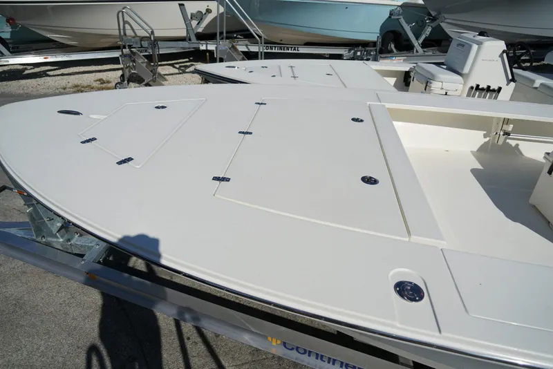 Slide: The Image of 2025 Hewes Redfisher 21 boat deck on trailer, showcasing storage compartments. - 8