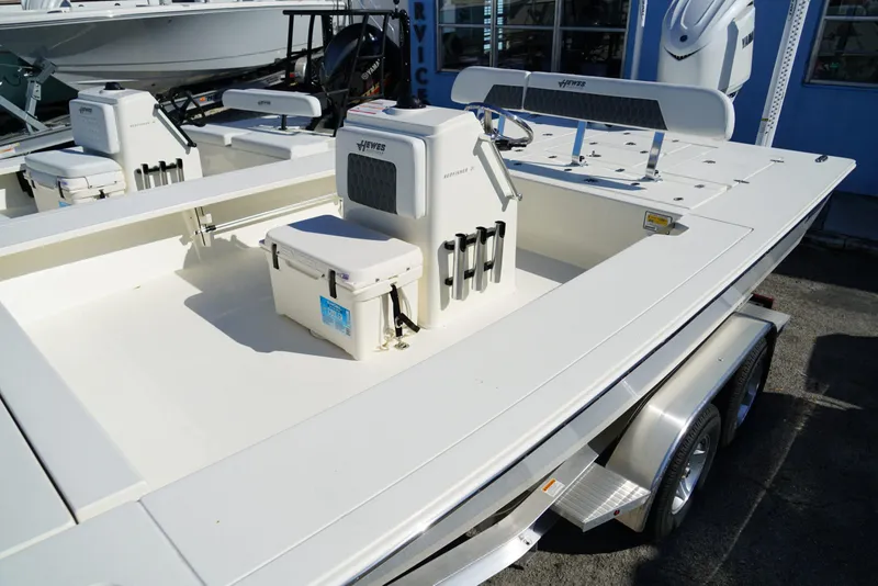 Slide: The Image of 2025 Hewes Redfisher 21 boat on trailer, featuring spacious deck and seating. - 9