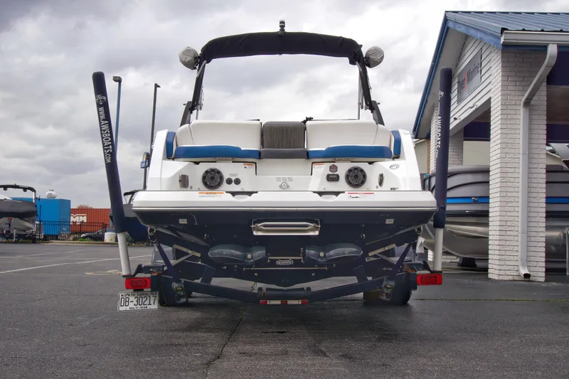 Slide: The Image of 2020 Scarab 255 ID boat, rear view, parked outdoors near a building. - 7