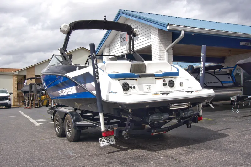 Slide: The Image of 2020 Scarab 255 ID boat on trailer, parked outside a dealership. - 8
