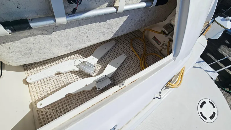 Slide: The Image of 2003 Sea Ray 410 Express Cruiser storage compartment with equipment and cables. - 11