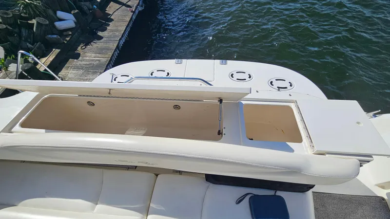 Slide: The Image of 2003 Sea Ray 410 Express Cruiser open storage compartment on deck by the water. - 18