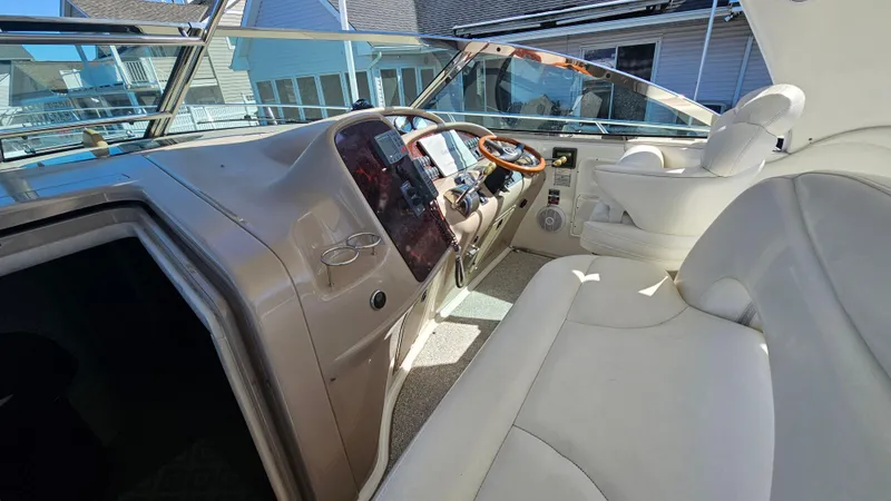 Slide: The Image of 2003 Sea Ray 410 Express Cruiser cockpit with leather seating and modern controls. - 25