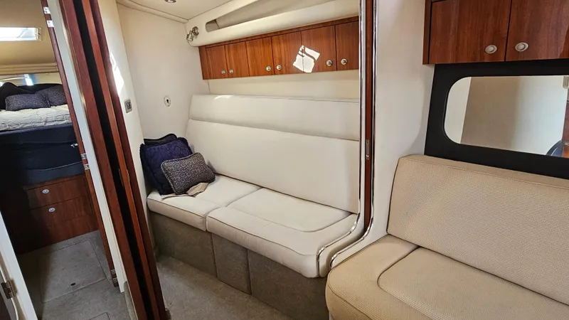 Slide: The Image of Interior of 2003 Sea Ray 410 Express Cruiser with comfortable seating and wooden cabinetry. - 31