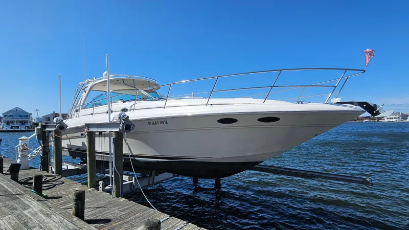 Slide: The Image of 2003 Sea Ray 410 Express Cruiser docked on a sunny day. - 4