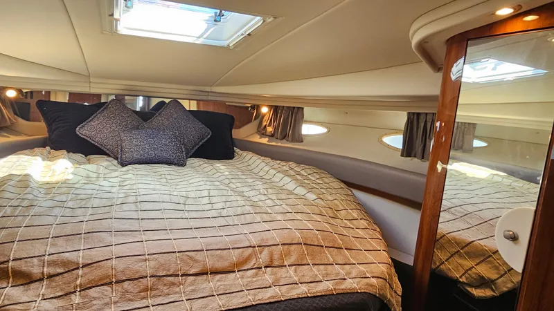 Slide: The Image of Luxurious cabin interior of 2003 Sea Ray 410 Express Cruiser with cozy bedding. - 42