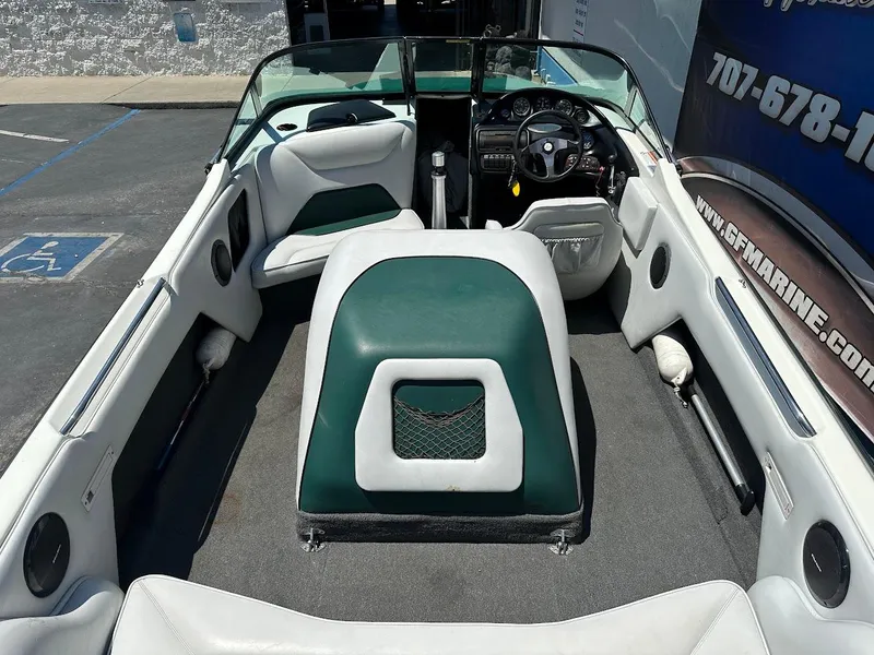 Slide: The Image of 1998 Ski Centurion sport bowrider interior with green and white seating, steering wheel, and dashboard. - 10