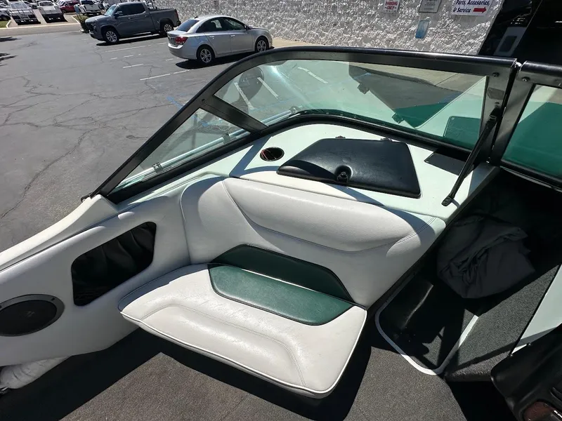 Slide: The Image of 1998 Ski Centurion sport bowrider interior with white and green seating, parked in a lot. - 18
