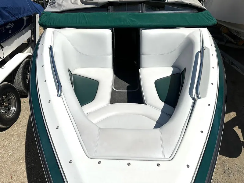 Slide: The Image of 1998 Ski Centurion sport bowrider boat with white and green seating. - 26