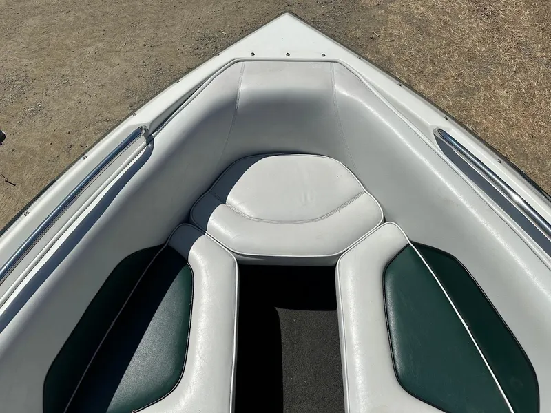 Slide: The Image of 1998 Ski Centurion sport bowrider boat interior with white and green seating. - 27