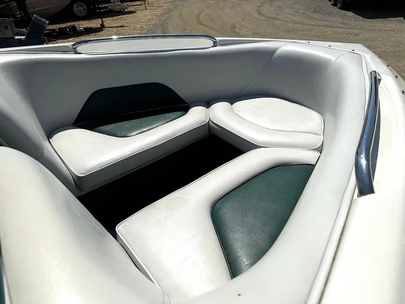 Slide: The Image of 1998 Ski Centurion sport bowrider interior with white and green cushioned seating. - 28