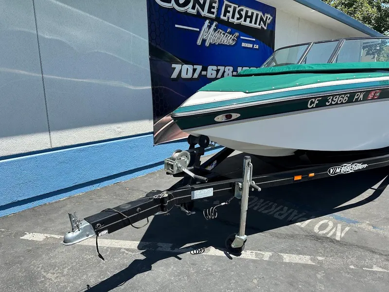 Slide: The Image of 1998 Ski Centurion sport bowrider on trailer, parked outside a marine dealership. - 4