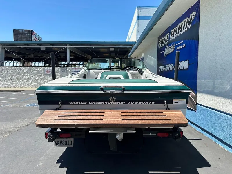 Slide: The Image of 1998 Ski Centurion sport bowrider boat, rear view, parked outdoors. - 7