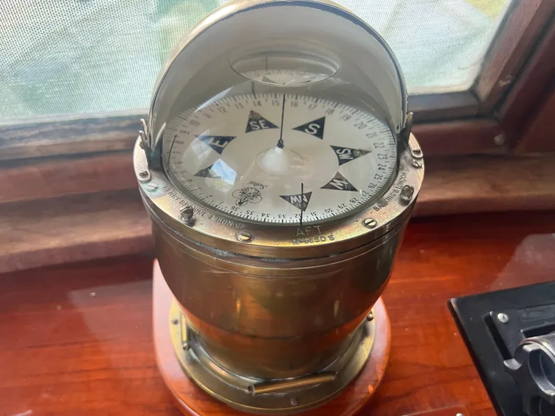 Slide: The Image of Vintage 1965 Romsdal Fjord ship compass on wooden surface, nautical navigation instrument. - 11